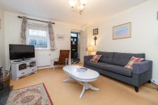Aughrim Holiday Village No. 14. Aughrim holiday village. Living room, modern comfortable sofas, coffee table and TV. Bright