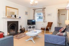 Aughrim Holiday Village No. 14. Aughrim holiday village. Living room, modern comfortable sofas, open fire. Bright interior. 
