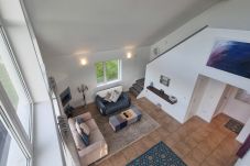 Riverrun Holiday Home No 15. Open plan view of living room from mezzanine level.