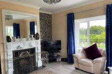 Ballygarrett Holiday Home, County Wexford. Bright living room with open fire. 