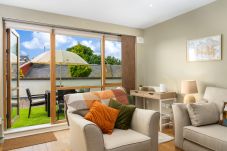 Clifden Town Apartment.Well finished modern interior lounge with access to garden. Patio doors.