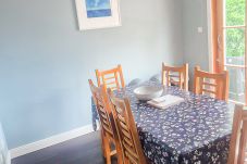 Dingle Town Holiday Home. Dining table seating six with large window and a vew of garden. 